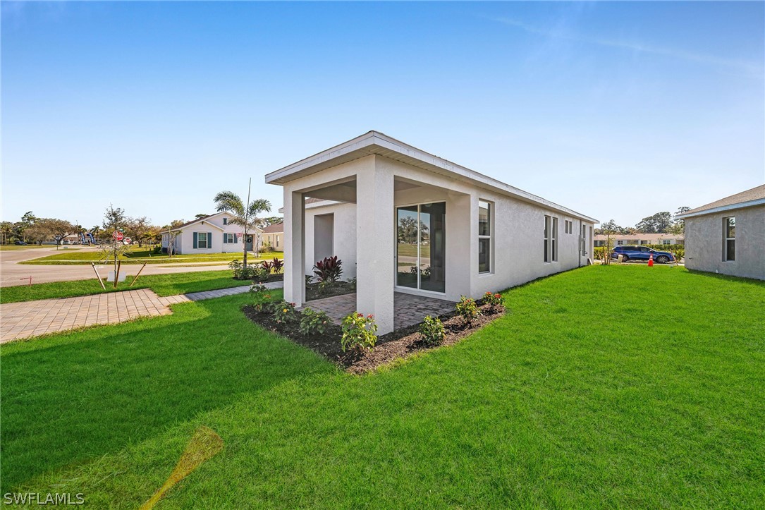 900 Friendship Circle LaBelle, FL 33935 - Photo 20 of 21 a front view of house with yard and green space