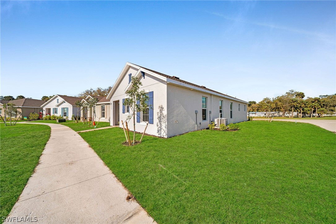 900 Friendship Circle LaBelle, FL 33935 - Photo 2 of 21 a view of a house with backyard and garden