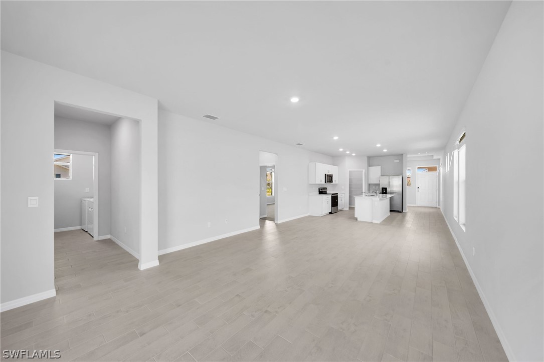 900 Friendship Circle LaBelle, FL 33935 - Photo 3 of 21 a view of empty room with a kitchen