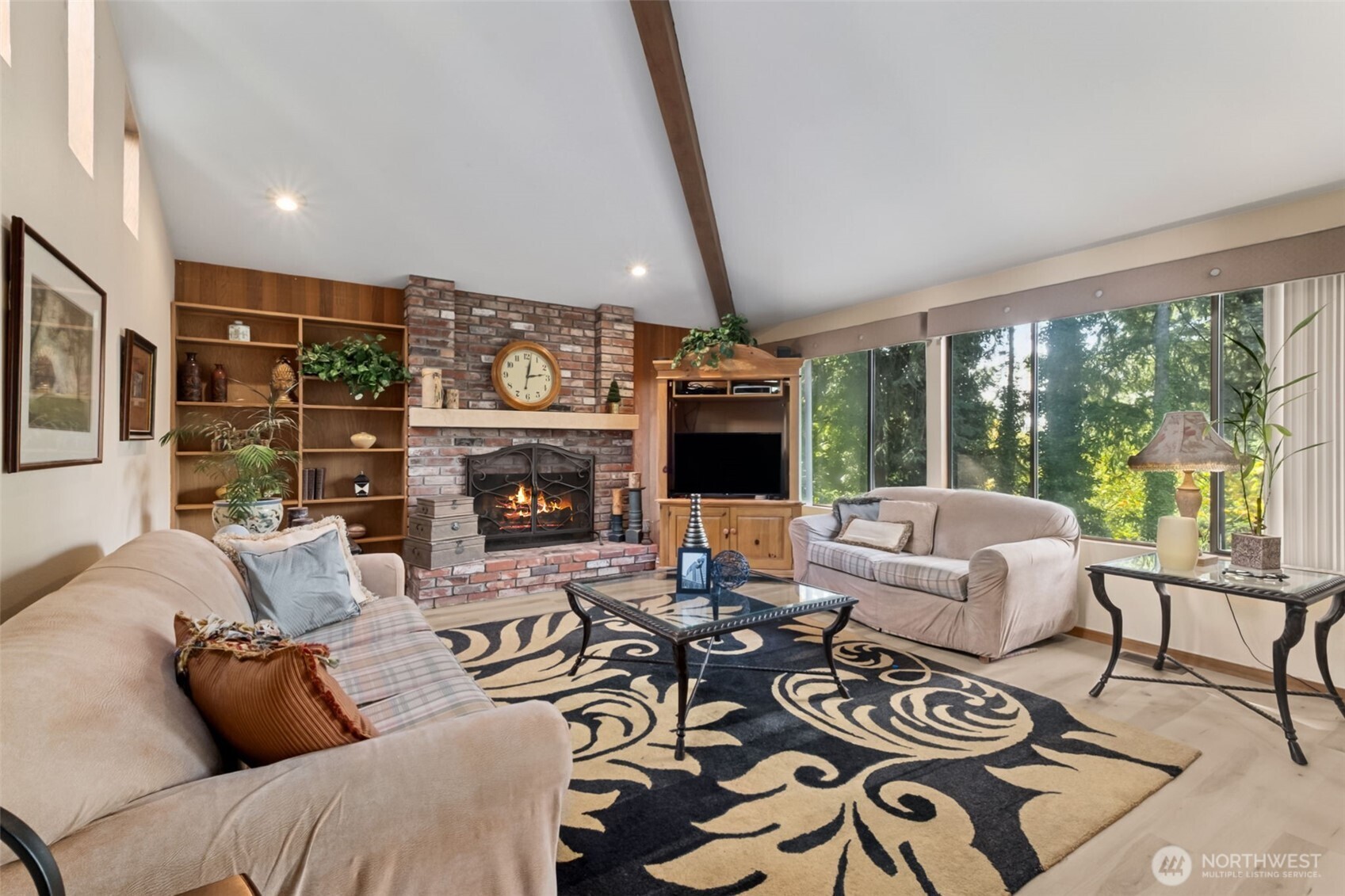 22505 241st Avenue Southeast Maple Valley, WA 98038 - Photo 14 of 30 a living room with furniture a large window and a fireplace