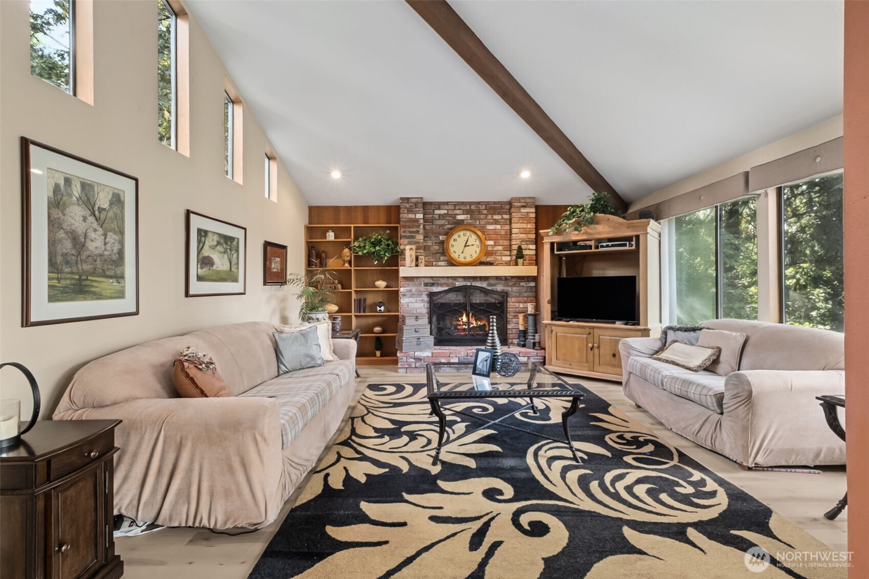 22505 241st Avenue Southeast Maple Valley, WA 98038 - Photo 15 of 30 a living room with furniture a large window and a fireplace