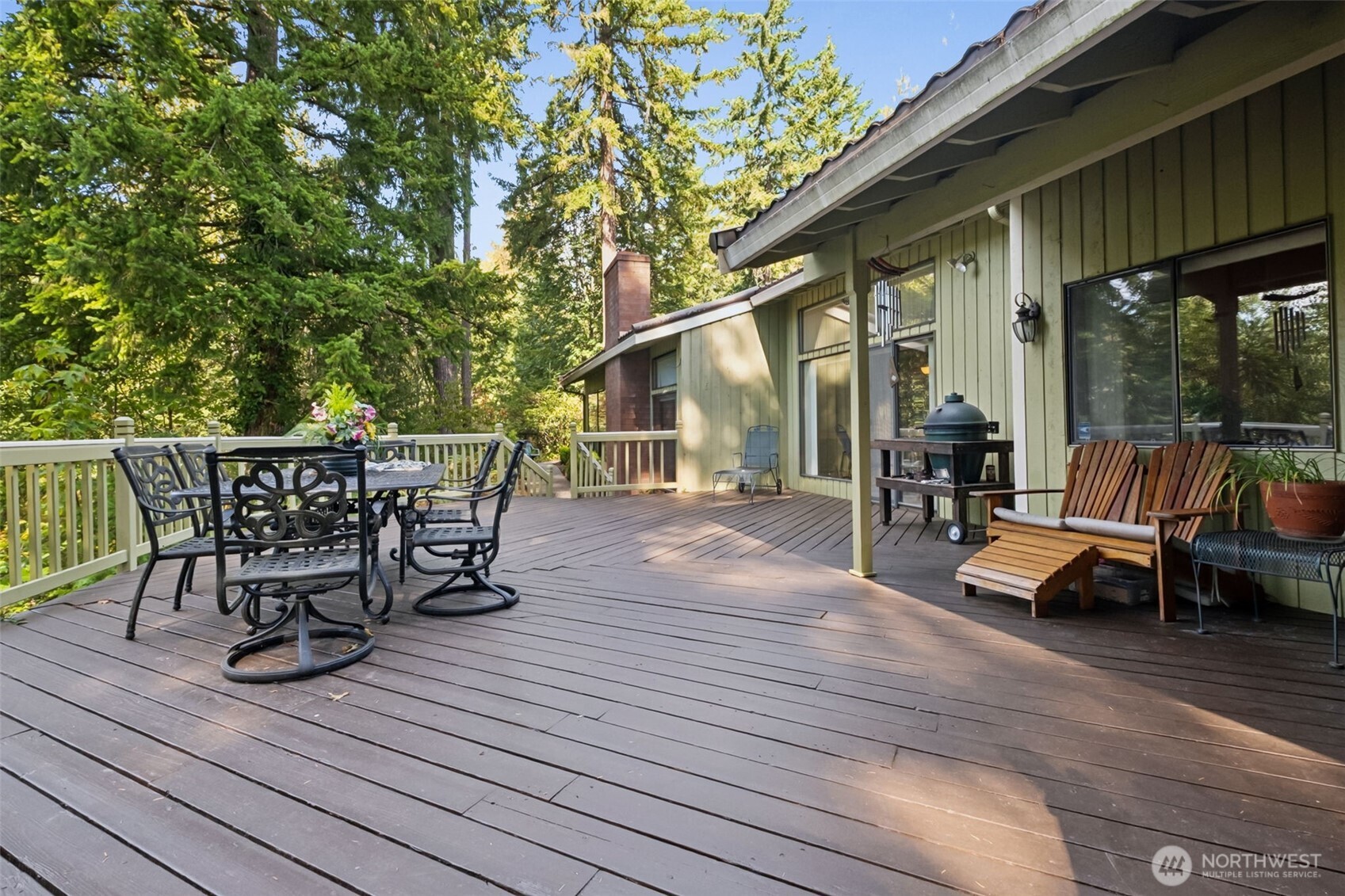 22505 241st Avenue Southeast Maple Valley, WA 98038 - Photo 27 of 30 a view of a patio with table and chairs and wooden floor