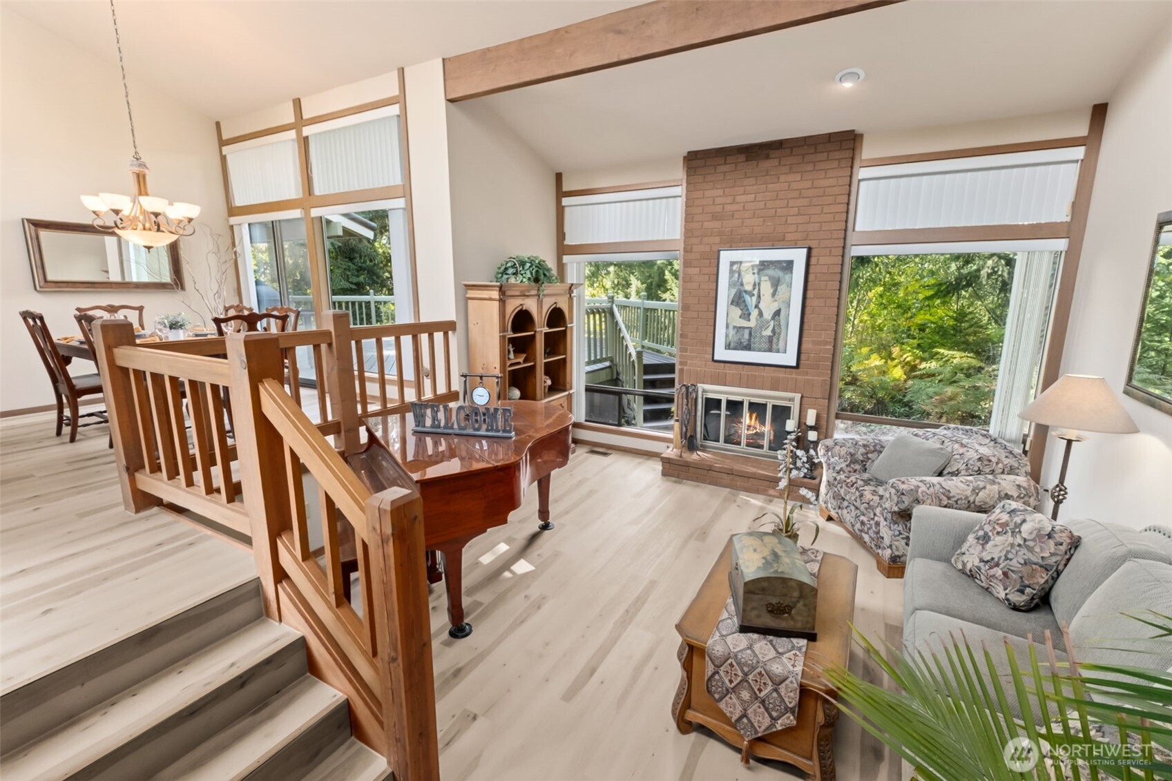 22505 241st Avenue Southeast Maple Valley, WA 98038 - Photo 5 of 30 a living room with furniture stairs and a large window