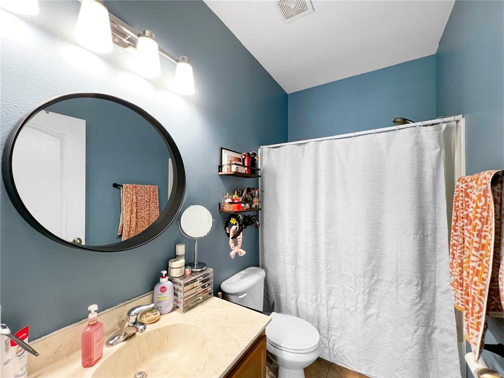 15767 Stable Run Drive Spring Hill, FL 34610 - Photo 24 of 34 a bathroom with a sink mirror and toilet