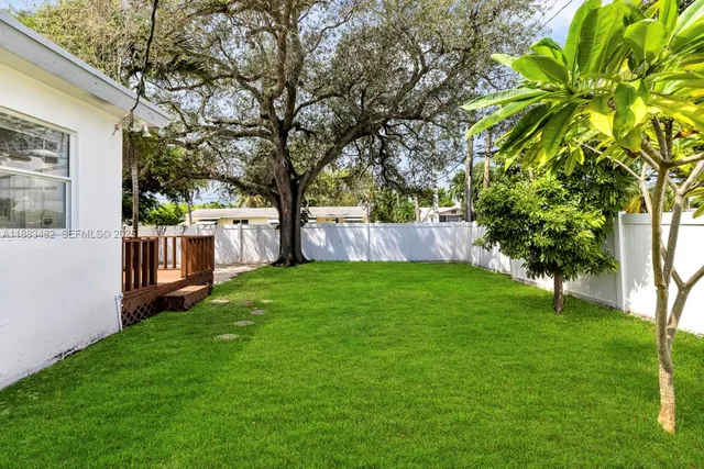 a view of a backyard with a large tree