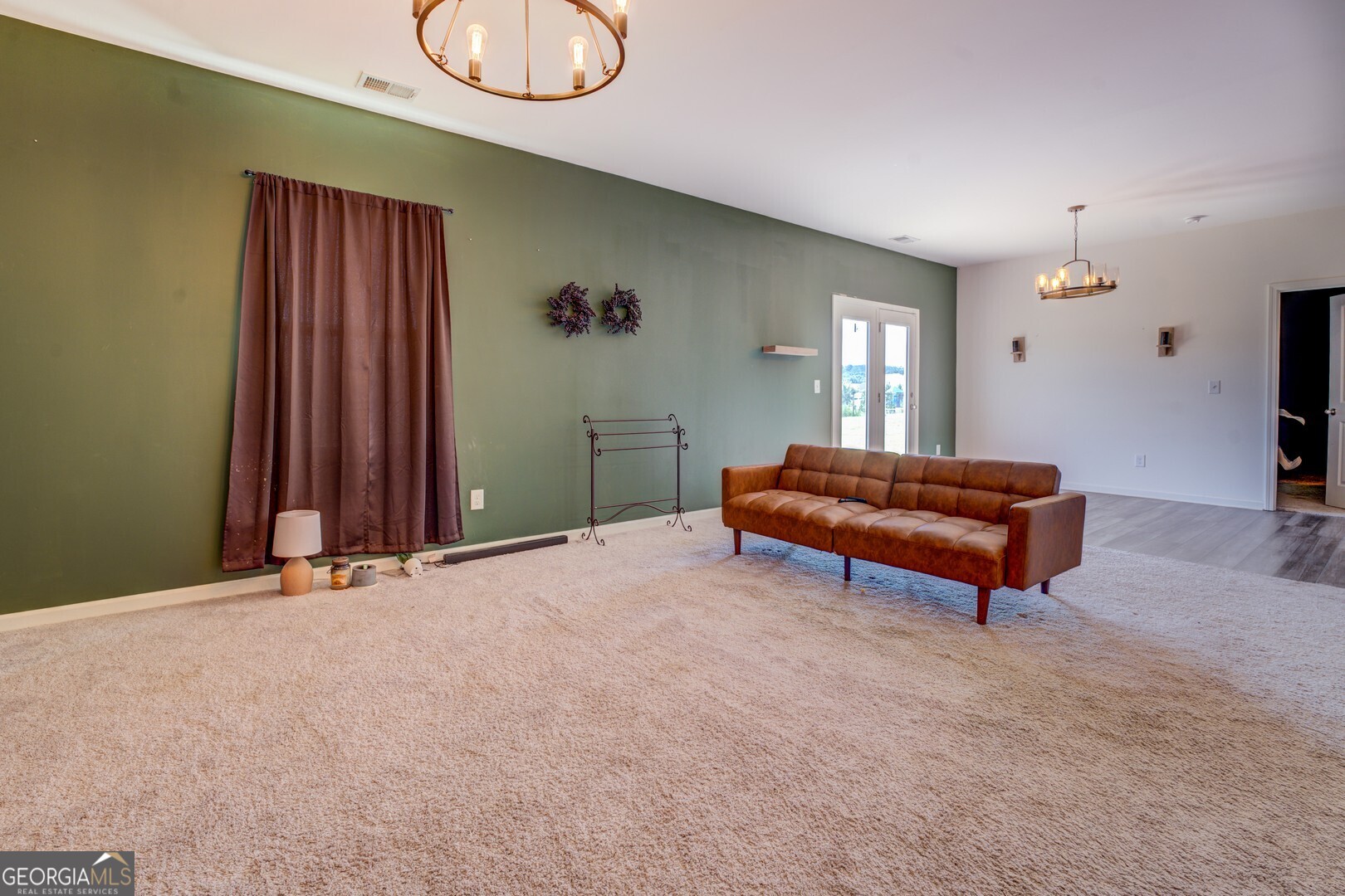 89 Dorsey Way Monroe, GA 30655 - Photo 18 of 26 a room with a couch and a chandelier
