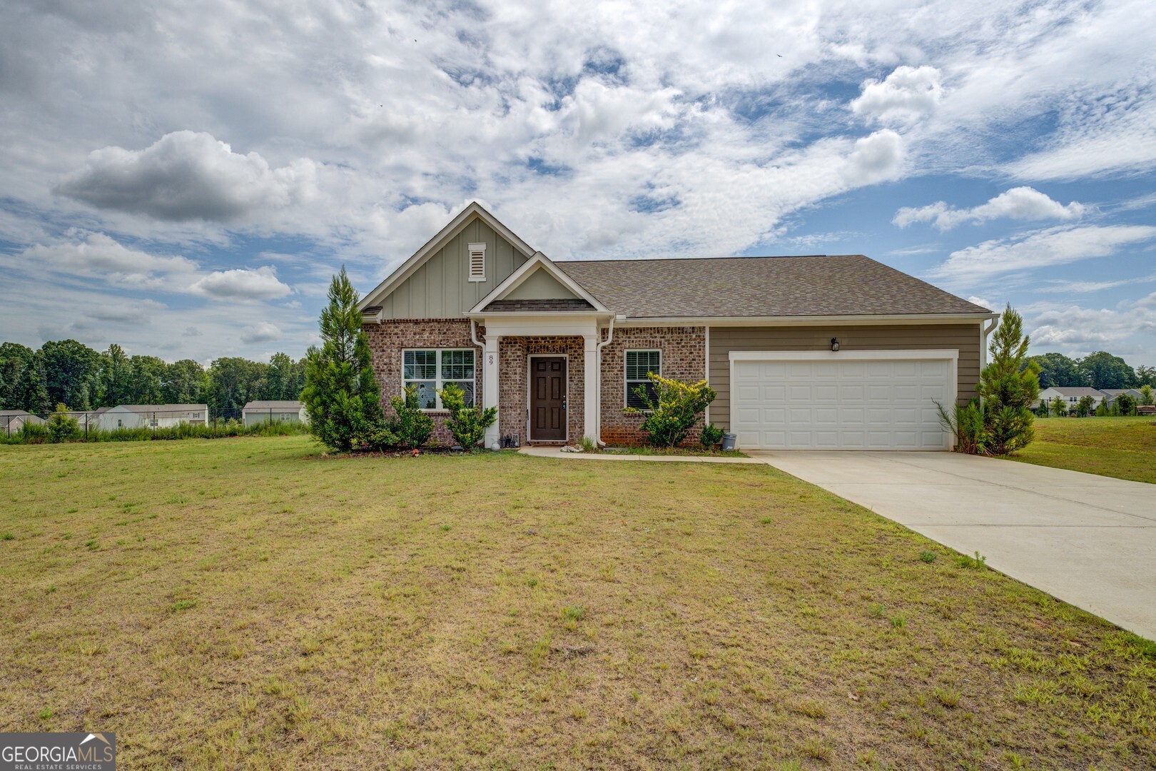 89 Dorsey Way Monroe, GA 30655 - Photo 2 of 26 a front view of a house with a garden