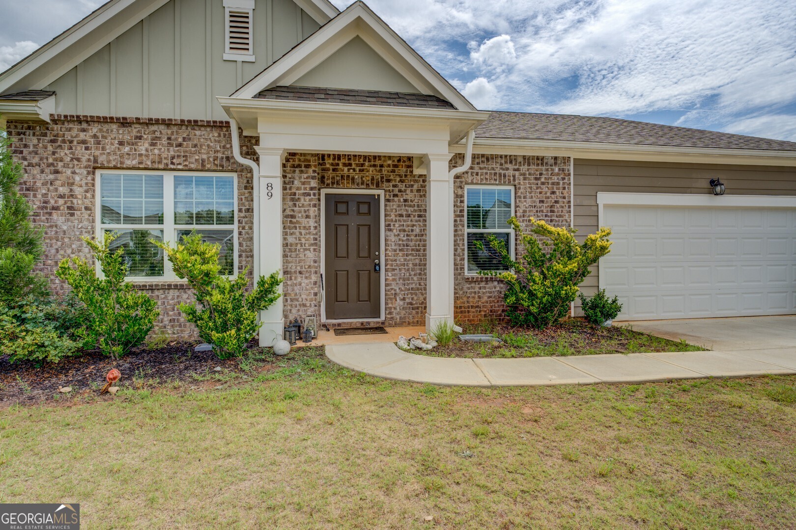 89 Dorsey Way Monroe, GA 30655 - Photo 3 of 26 a front view of a house with a yard