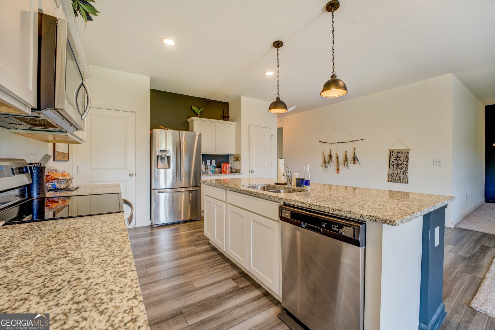 89 Dorsey Way Monroe, GA 30655 - Photo 6 of 26 a kitchen with stainless steel appliances granite countertop a sink a stove and a refrigerator