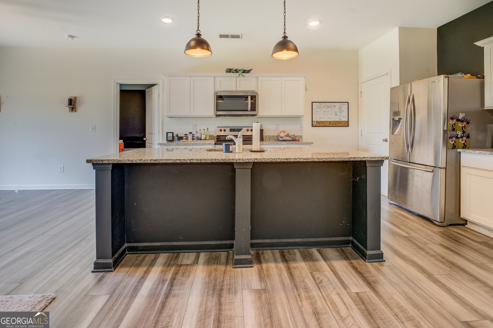 89 Dorsey Way Monroe, GA 30655 - Photo 8 of 26 a kitchen with stainless steel appliances granite countertop a sink and a refrigerator