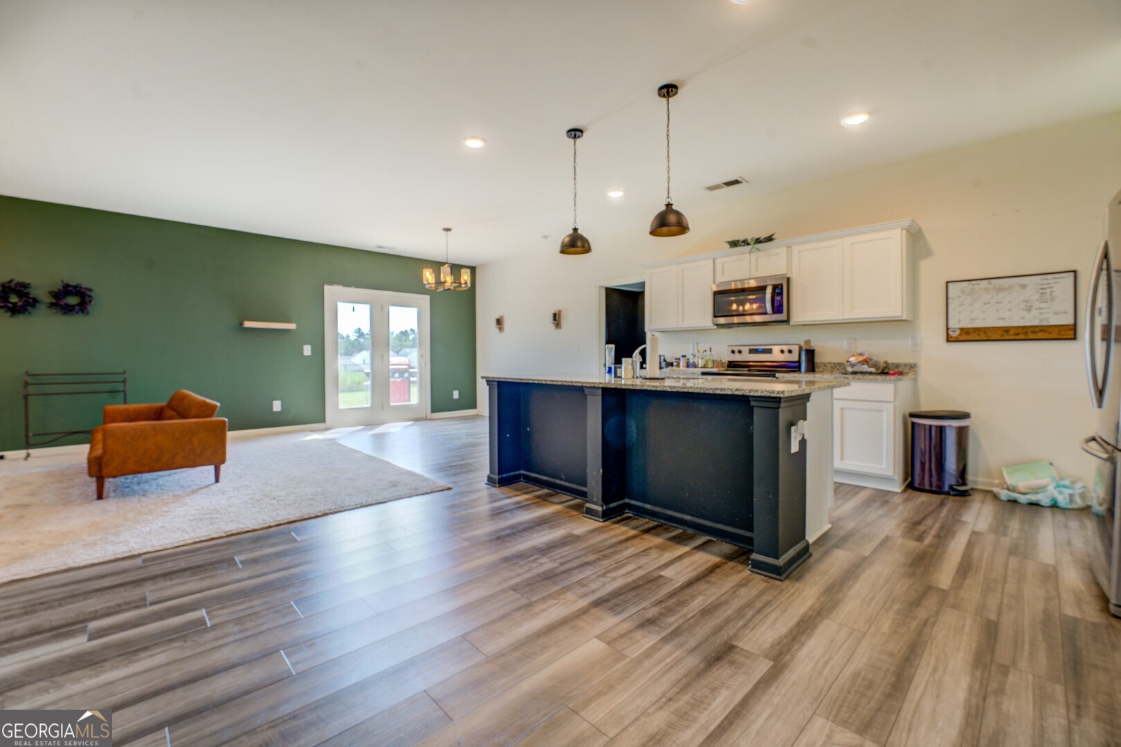 89 Dorsey Way Monroe, GA 30655 - Photo 10 of 26 a kitchen with stainless steel appliances granite countertop a sink dishwasher and a stove with wooden floor