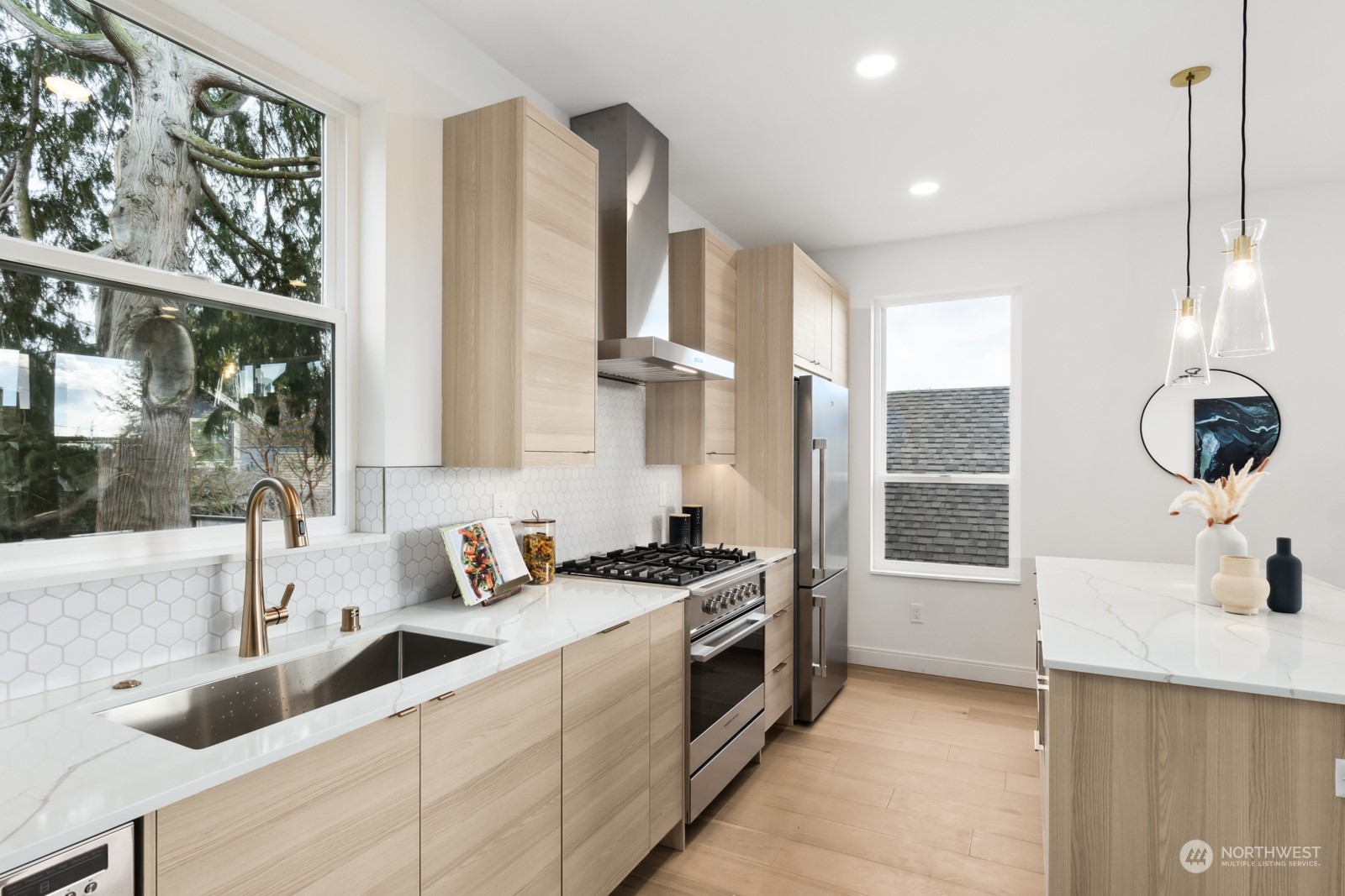 356 North 75th Street, Unit B Seattle, WA 98103 - Photo 12 of 32 a kitchen with stainless steel appliances a sink stove and a window