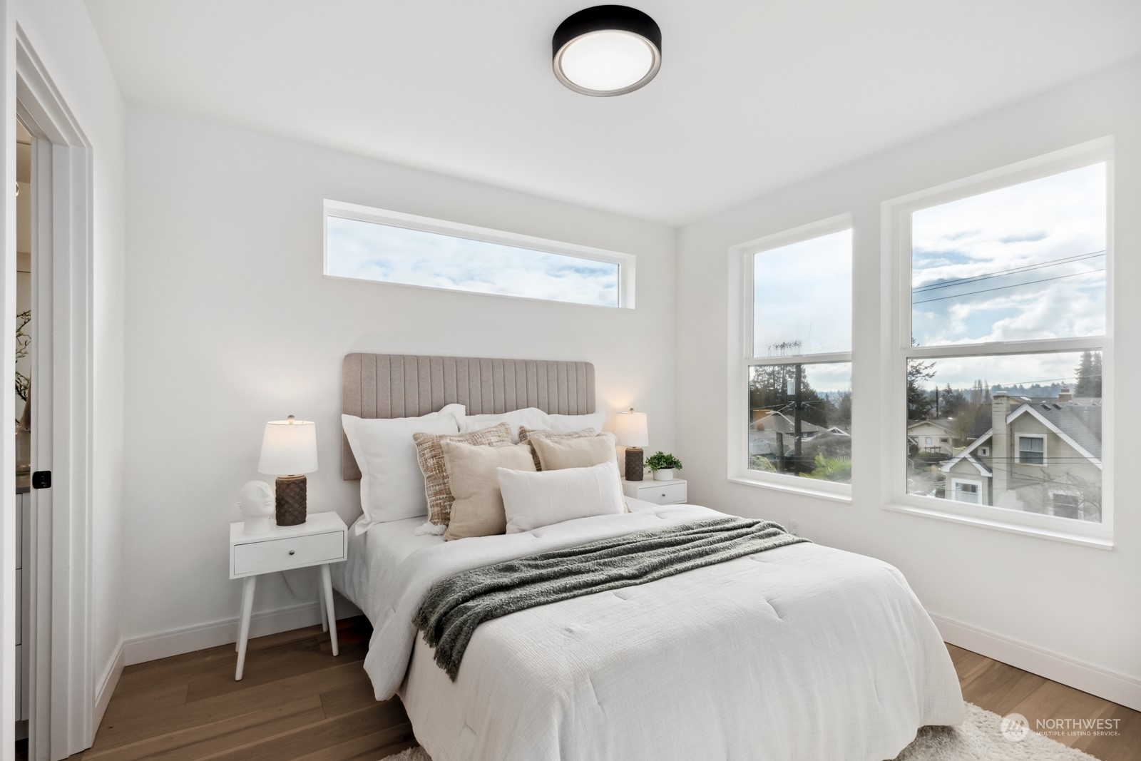 356 North 75th Street, Unit B Seattle, WA 98103 - Photo 15 of 32 a bedroom with a large bed and a large window