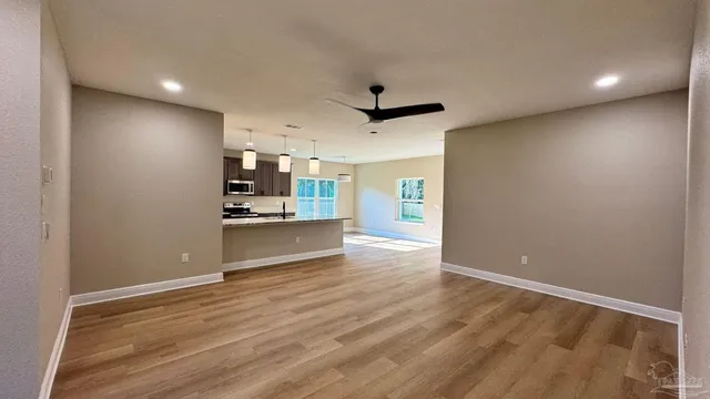 a kitchen with counter top space and wooden floor