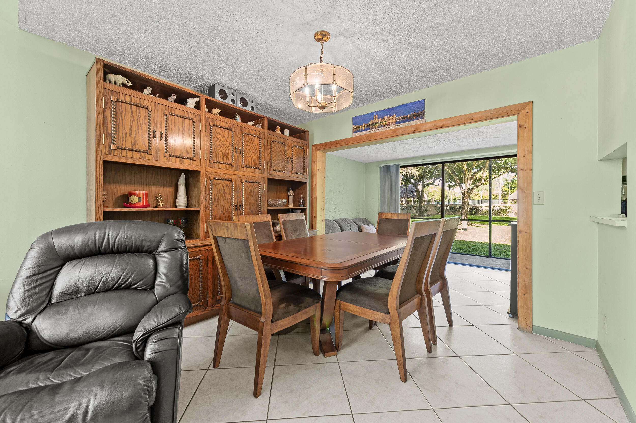 22384 Thousand Pines Lane Boca Raton, FL 33428 - Photo 17 of 45 a dining room with furniture a fireplace and a chandelier