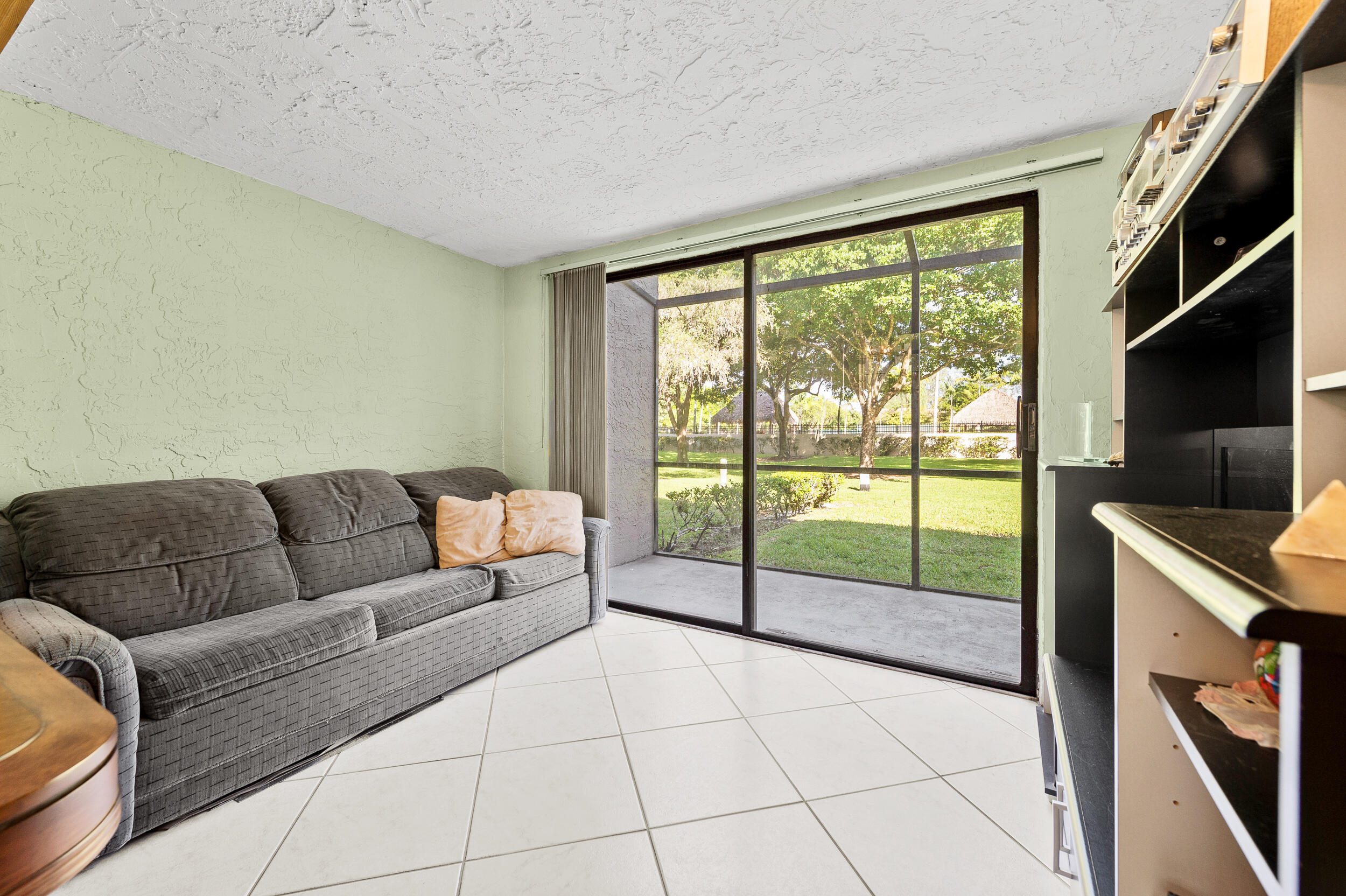 22384 Thousand Pines Lane Boca Raton, FL 33428 - Photo 18 of 45 a living room with furniture and a flat screen tv