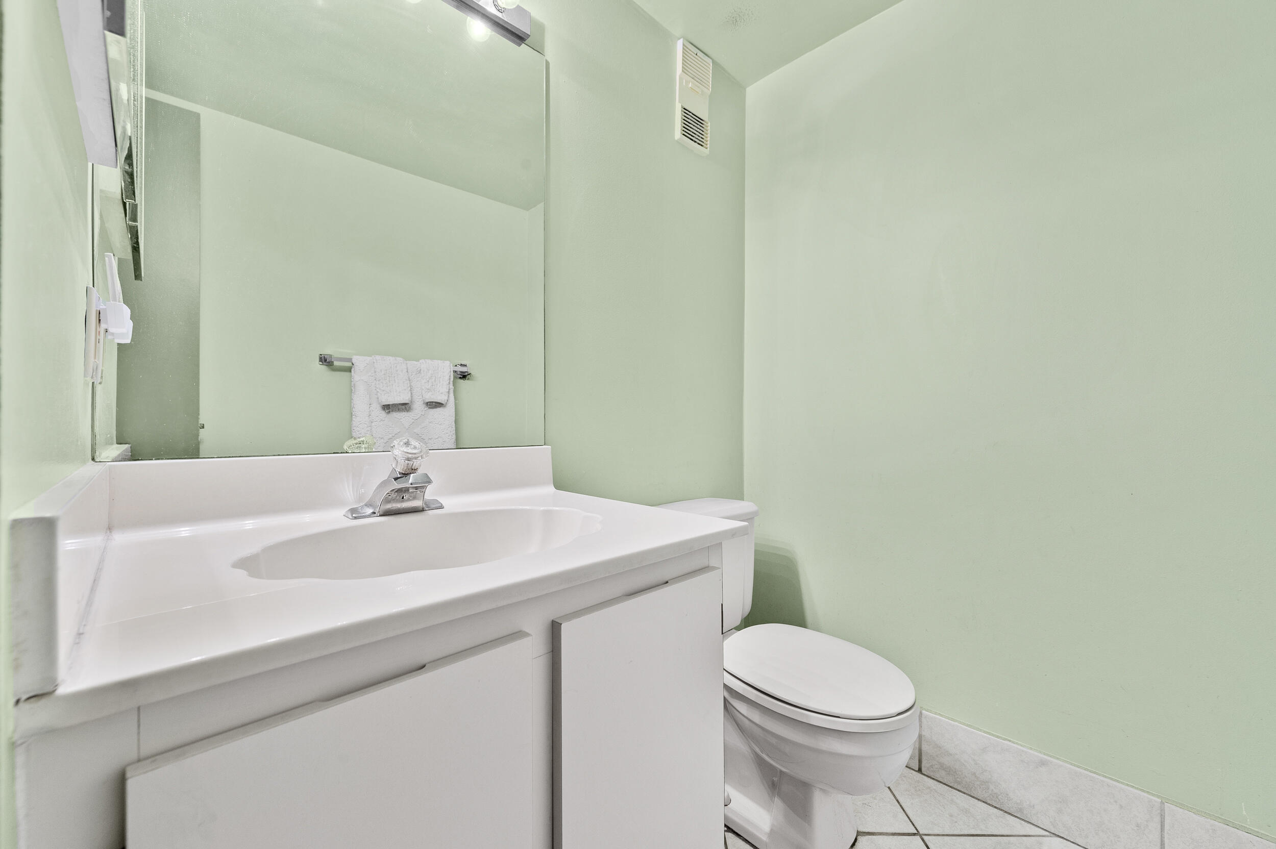 22384 Thousand Pines Lane Boca Raton, FL 33428 - Photo 20 of 45 a bathroom with a sink a toilet and mirror