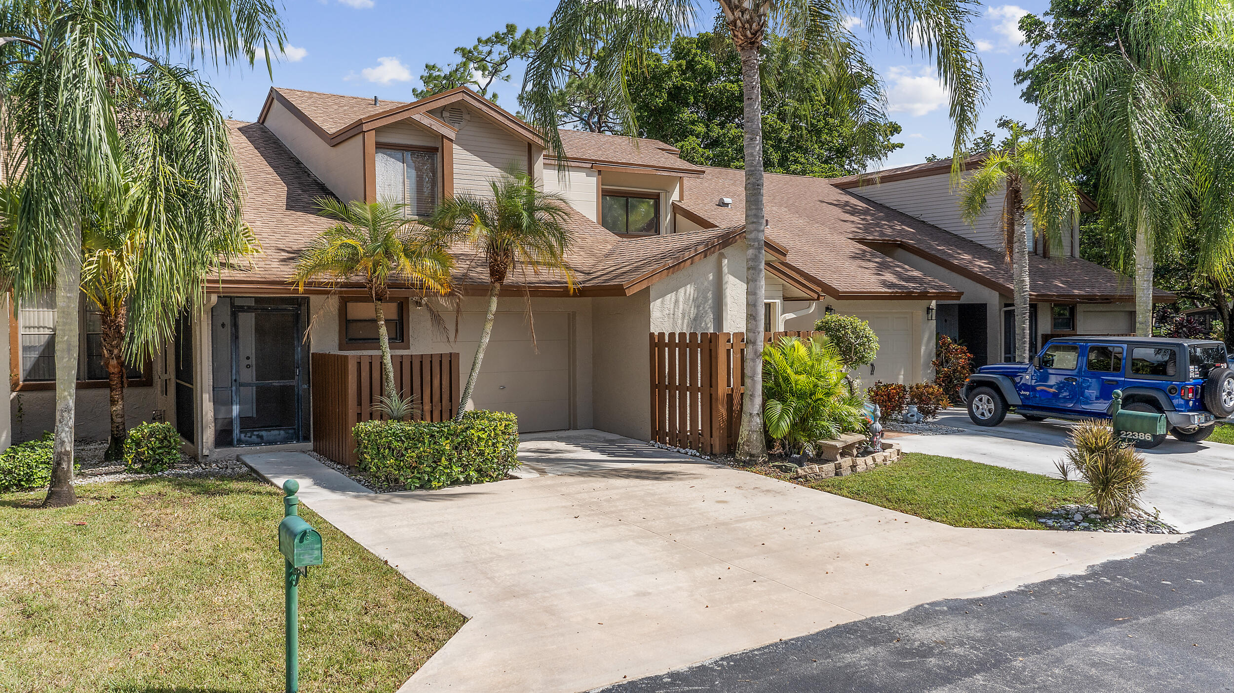 22384 Thousand Pines Lane Boca Raton, FL 33428 - Photo 3 of 45 a front view of a house with garden