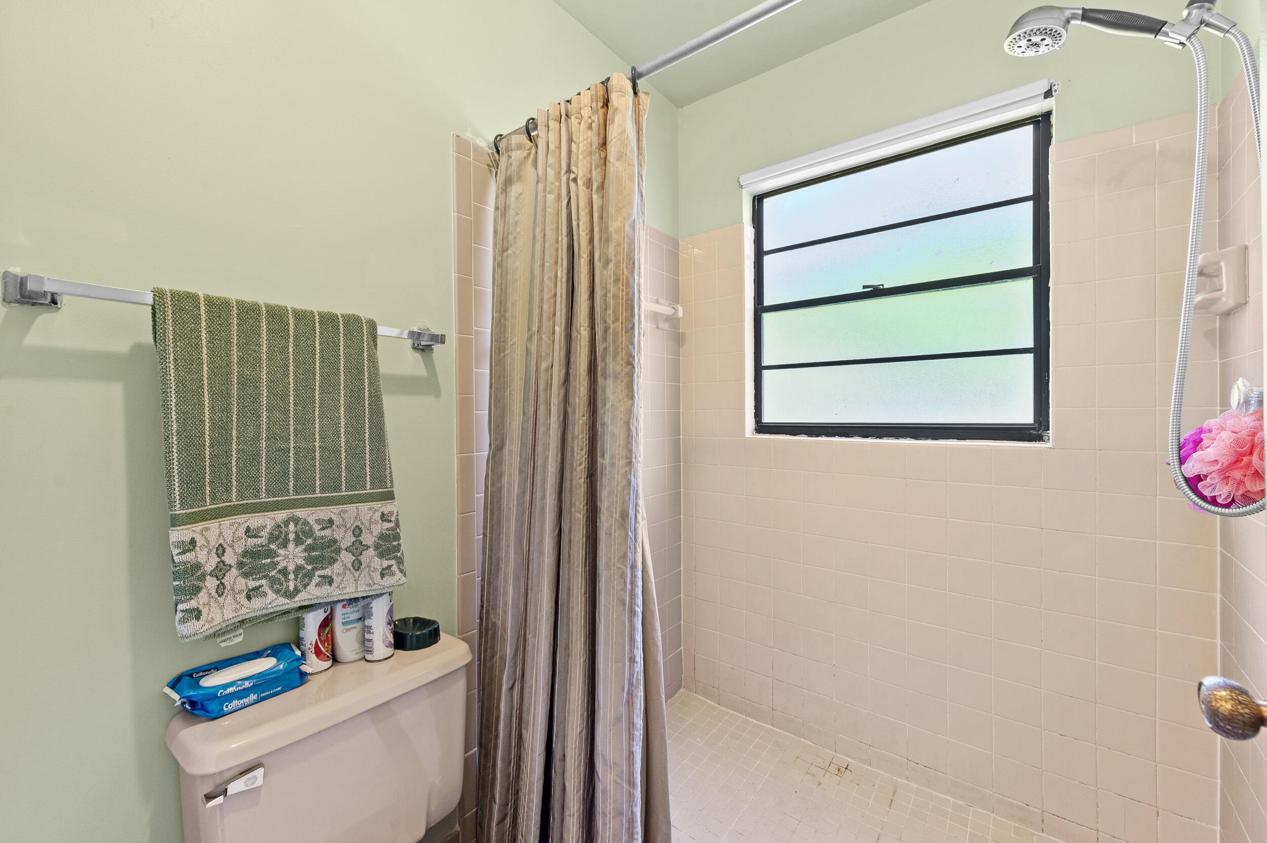 22384 Thousand Pines Lane Boca Raton, FL 33428 - Photo 36 of 45 a bathroom with a toilet and a shower curtain