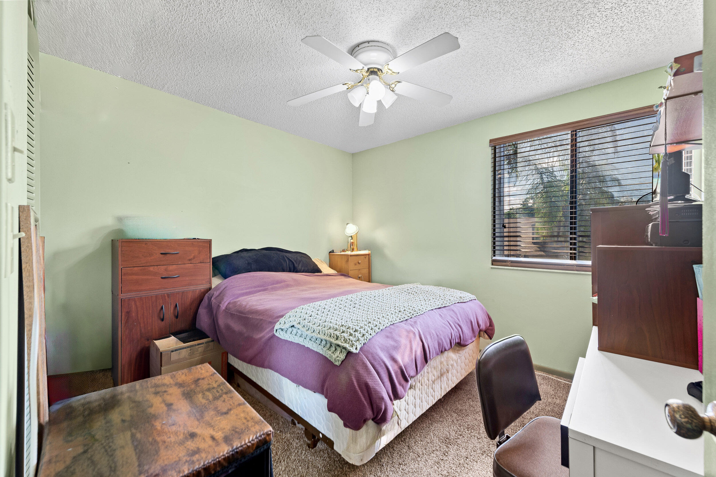 22384 Thousand Pines Lane Boca Raton, FL 33428 - Photo 37 of 45 a bedroom with a bed and a chandelier