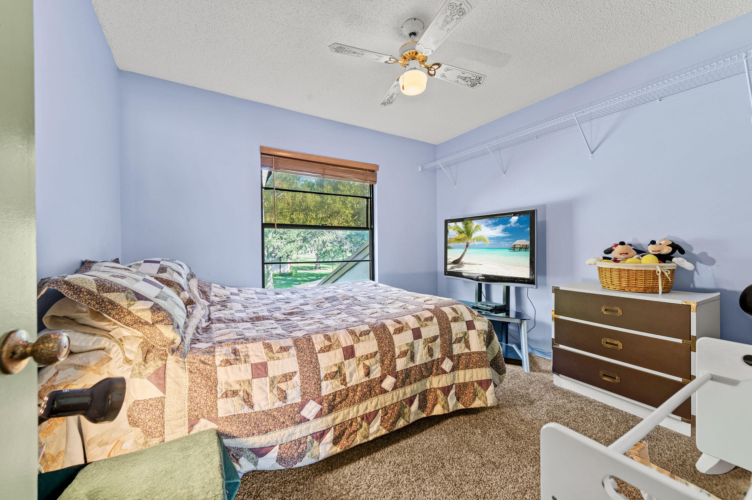 22384 Thousand Pines Lane Boca Raton, FL 33428 - Photo 39 of 45 a bedroom with a bed and a chandelier