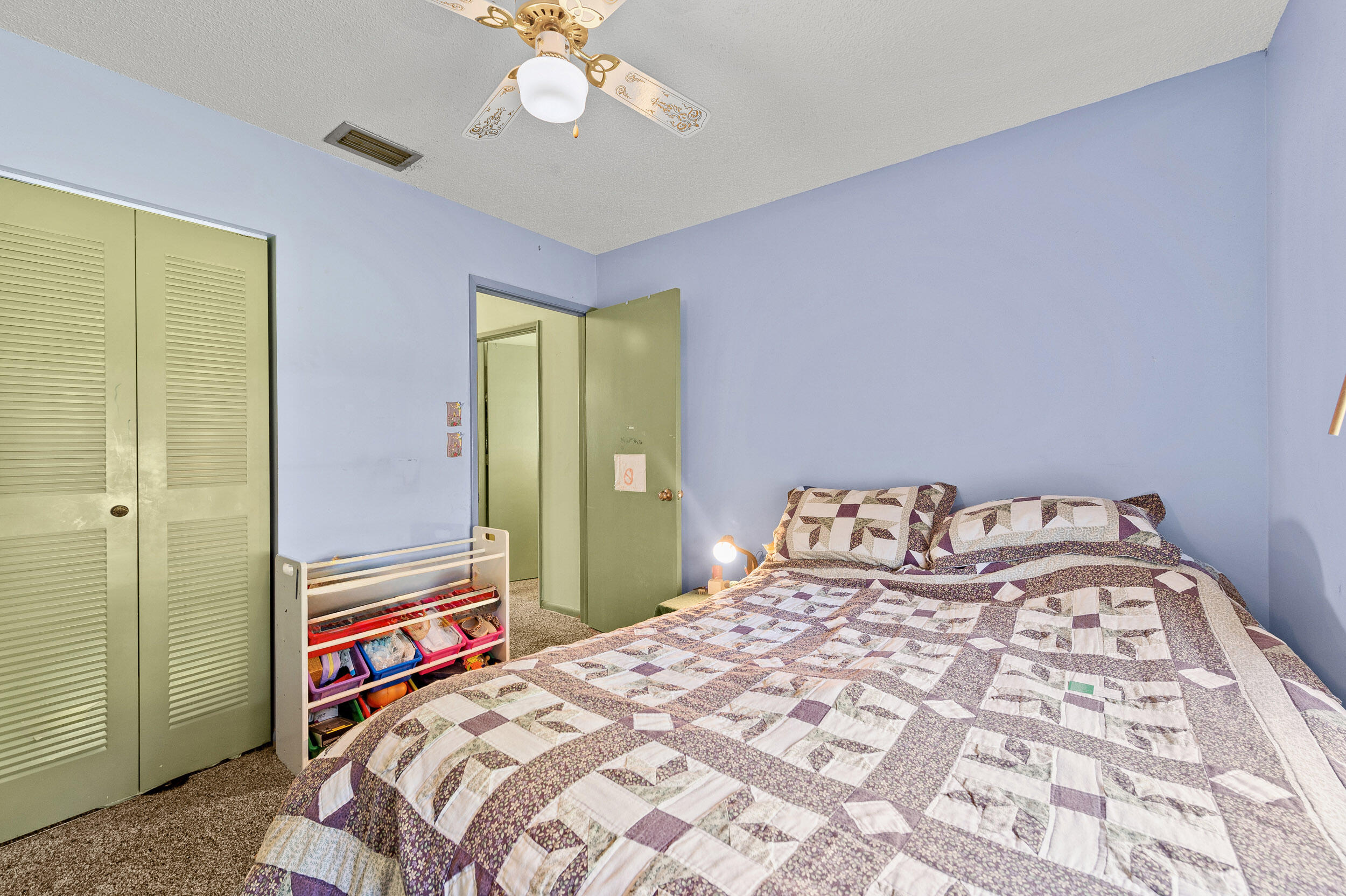 22384 Thousand Pines Lane Boca Raton, FL 33428 - Photo 40 of 45 a bedroom with a bed and a chandelier