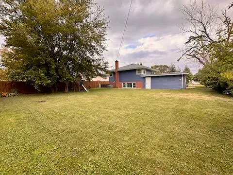 a view of a large pool with an outdoor space and seating area