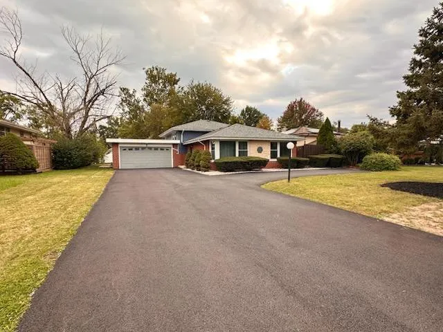 a view of a house with swimming pool and sitting area