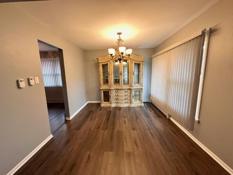 6839 West 127th Street Palos Heights, IL 60463 - Photo 3 of 15 wooden floor in an empty room with a window