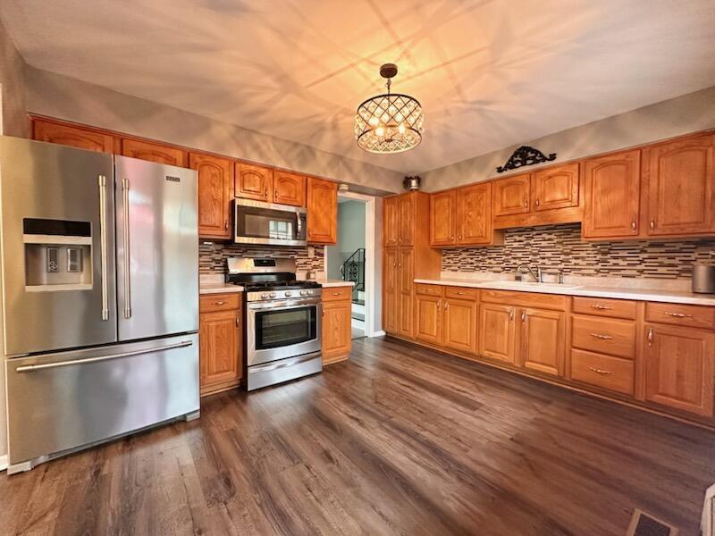 6839 West 127th Street Palos Heights, IL 60463 - Photo 4 of 15 a kitchen with stainless steel appliances granite countertop a refrigerator a stove top oven a sink and dishwasher