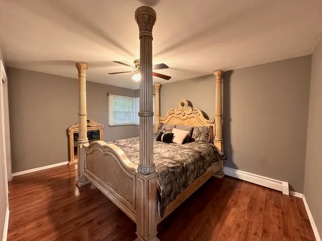 a bed sitting in a bedroom next to a window