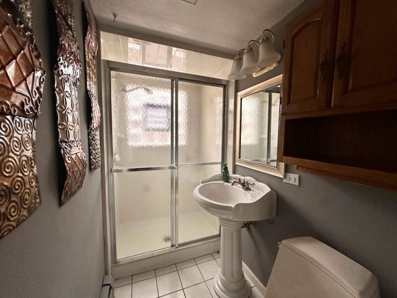 6839 West 127th Street Palos Heights, IL 60463 - Photo 10 of 15 a bathroom with a sink a mirror and a shower