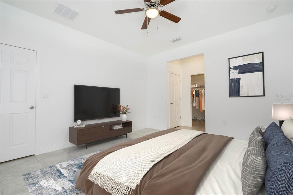 208 Locust Pass Ocala, FL 34472 - Photo 32 of 71 a bedroom with a bed and a flat tv screen on wall