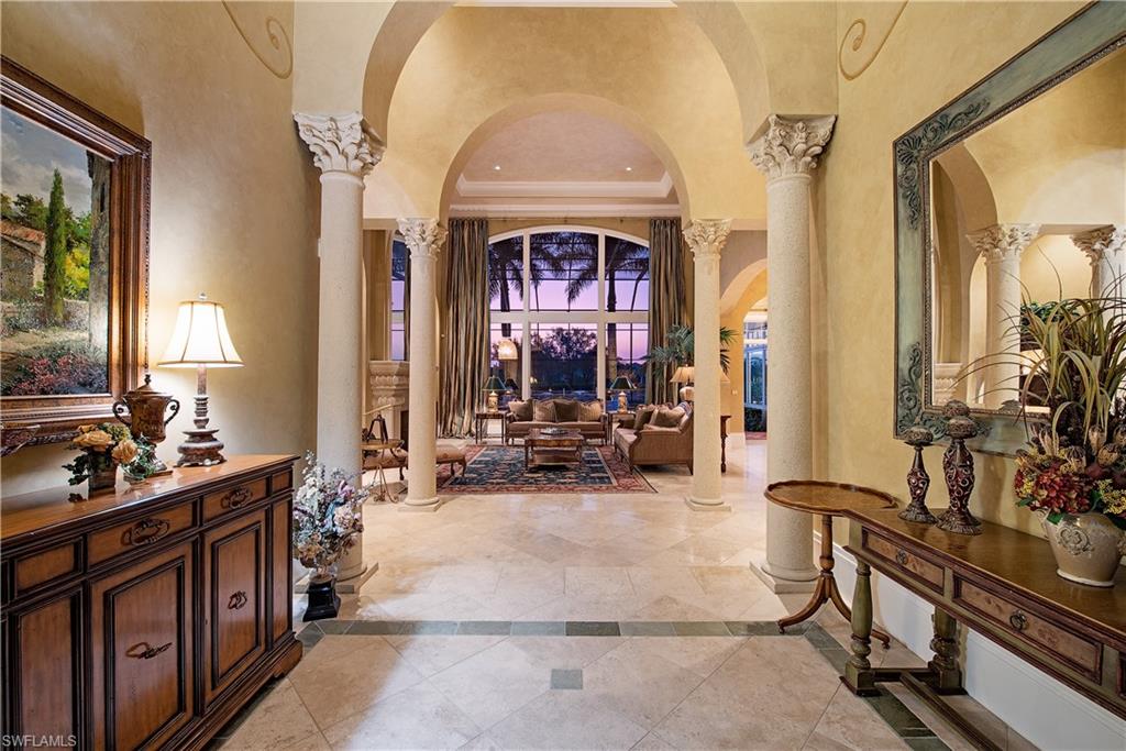 6265 Highcroft Drive Naples, FL 34119 - Photo 5 of 22 a living room with furniture a fireplace and potted plants