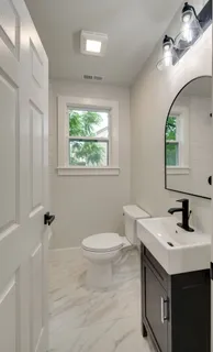 a bathroom with a sink toilet and a mirror