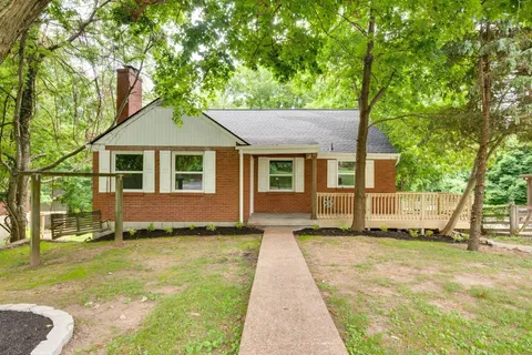 a house that has a tree in front of it
