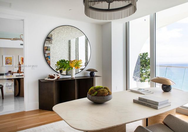 a living room with furniture and large windows