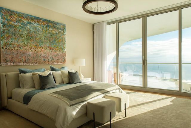 a bedroom with furniture and a large window