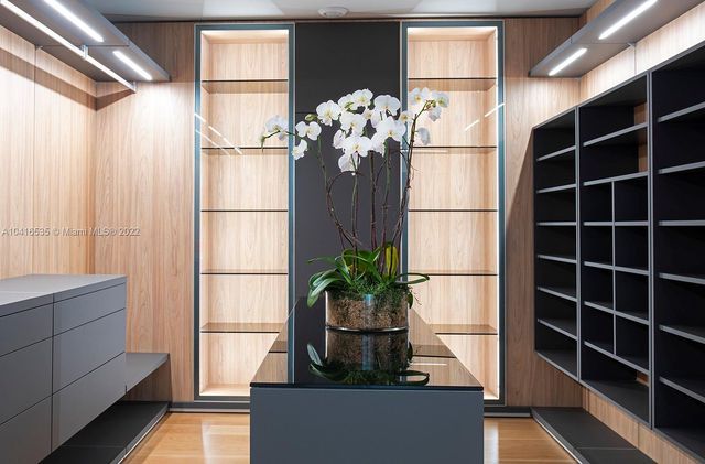 a bedroom with a large window and walk in closet