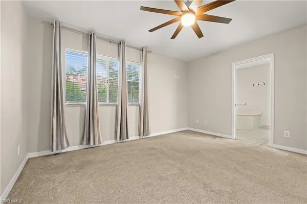 a view of a room with a ceiling fan and a window
