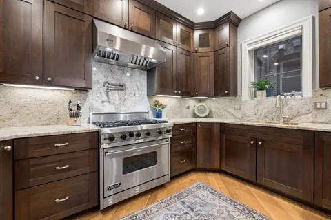 a kitchen with a stove oven and sink