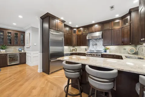 a kitchen with granite countertop a sink stove and refrigerator