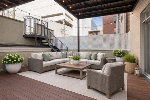 a view of a patio with couches and potted plants