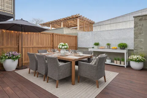 a view of outdoor dining space with a patio and a garden