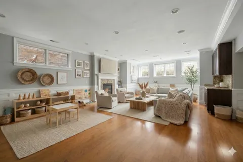 a living room with fireplace furniture and a flat screen tv