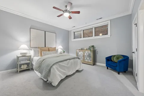 a bedroom with bed couch and window