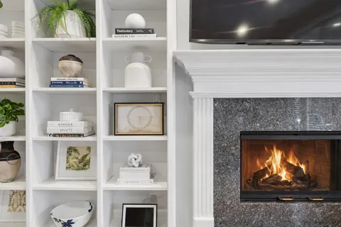 a living room with a fireplace and a wooden floor
