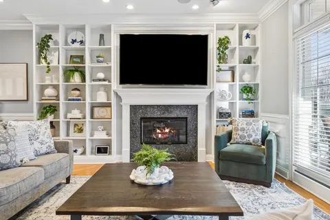a living room with furniture fireplace and flat screen tv