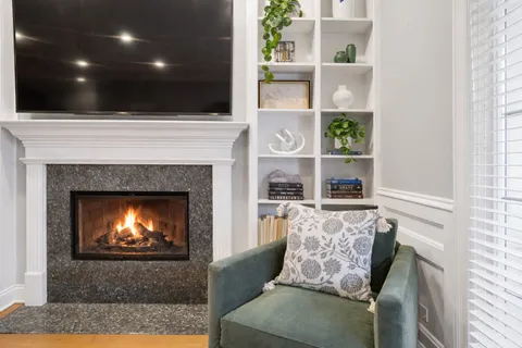 a living room with furniture and a fireplace