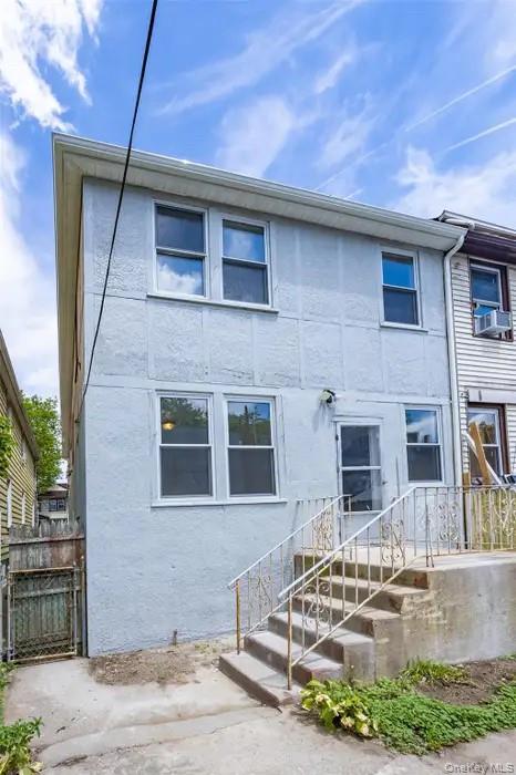 88-08 88th Street Queens, NY 11421 - Photo 14 of 32 a front view of a house with garden